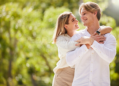 Buy stock photo Nature, smile and couple hug for happy, quality time and bonding on weekend, vacation and holiday together. Dating mockup, love and young man and woman hugging, relax and romantic embrace in park