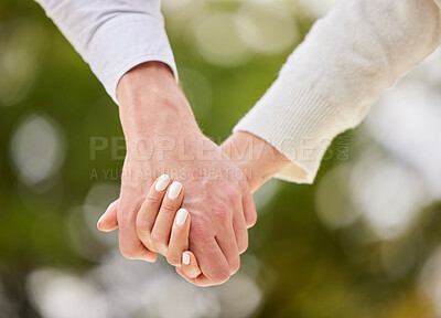 Buy stock photo Couple holding hands in park for love, date and marriage commitment together in summer garden. Closeup hand of man, woman and walking in nature, loyalty and care for partner, trust or support outdoor