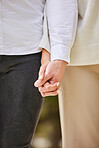 Closeup couple holding hands in park for love, date and marriage commitment together in summer garden. Hand of man, woman and walking outdoor, loyalty and care for partner, trust and calm romance 