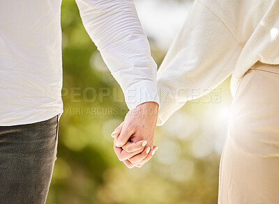 Buy stock photo Couple holding hands in park for love, care and save the date marriage commitment together. Closeup hand of man, woman and walking in nature, garden and sunshine for relax, trust and support partner