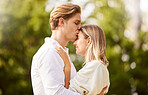 Dating, love and couple kiss in park for happy, quality time and bonding on weekend, vacation and holiday together. Engagement, relationship and young man and woman hugging, kissing and embrace