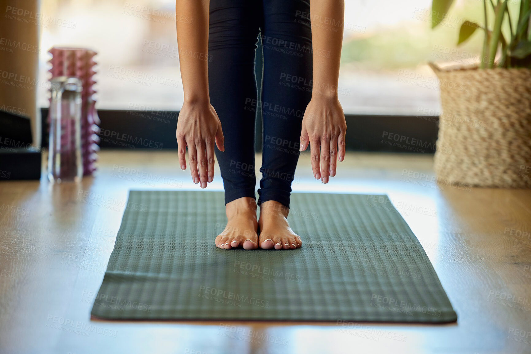 Buy stock photo Hands, feet and yoga with a woman in her home for a mental health, fitness or wellness workout. Exercise, pilates or stretching and a female yogi training with a forward bend alone for zen