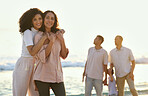 Hug, portrait and mother and daughter at the beach for vacation, family walk and bonding. Travel, love and elderly mom and woman hugging with affection while walking at the ocean in summer for peace