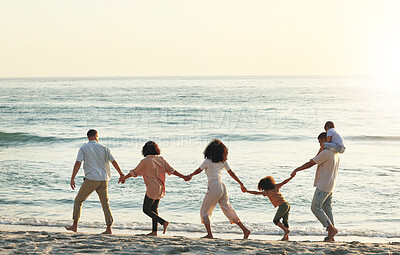 Buy stock photo Walking, big family and holding hands at beach at sunset, having fun and bonding on vacation outdoors. Care,  mockup and kids, grandmother and grandfather with parents at ocean enjoying holiday time.