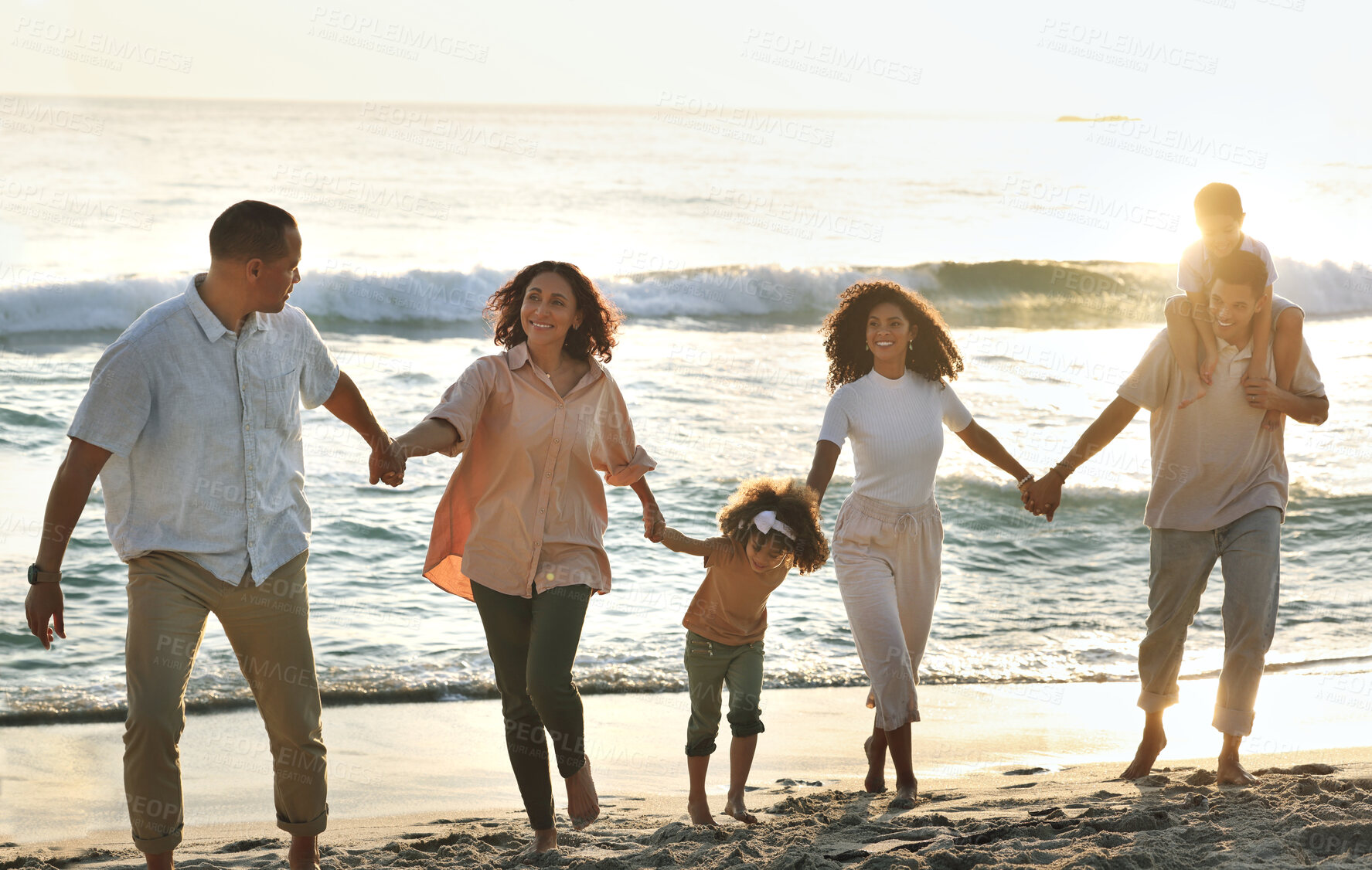 Buy stock photo Walking, happy and big family holding hands at the beach for vacation, trust and together in Bali. Travel, sunset and grandparents, children and parents on a walk by the sea for bonding and play