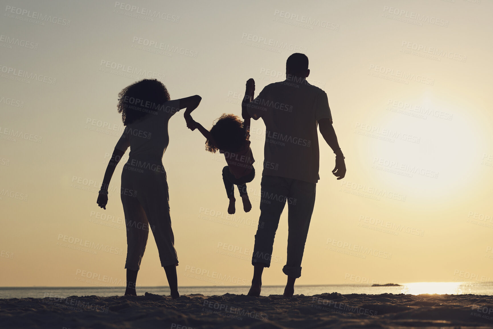 Buy stock photo Silhouette, beach and a family with children by the ocean, playing together in nature at sunset from the back. Summer, travel or love with a mother, father and kid having fun while bonding at the sea