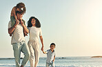 Happy, summer and walking family on the beach for travel, bonding and quality time in Brazil. Smile, together and parents with children on a walk by the ocean for playing, vacation and break