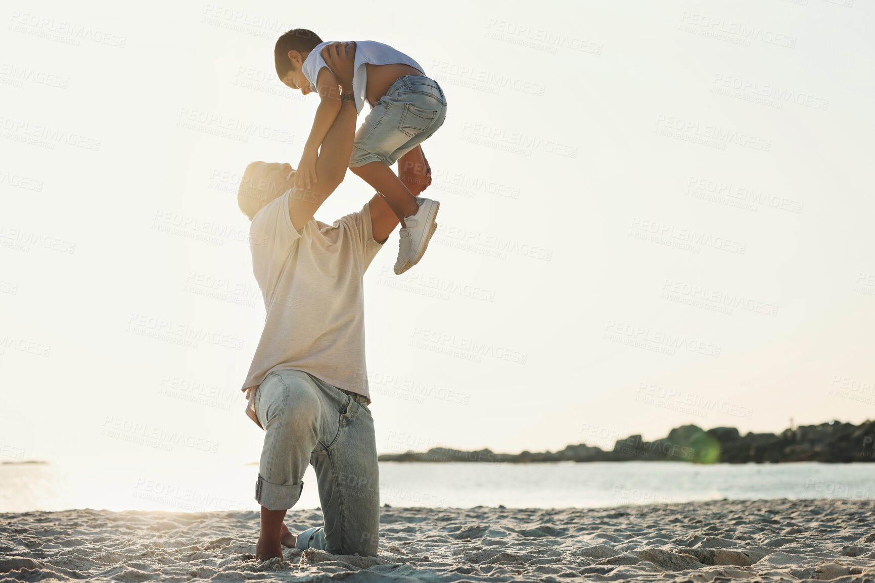 Buy stock photo Playing, bonding and father with a child at the beach for quality time, holiday and caring in Brazil. Family, love and dad holding his son for play, activity and together at the ocean for happiness