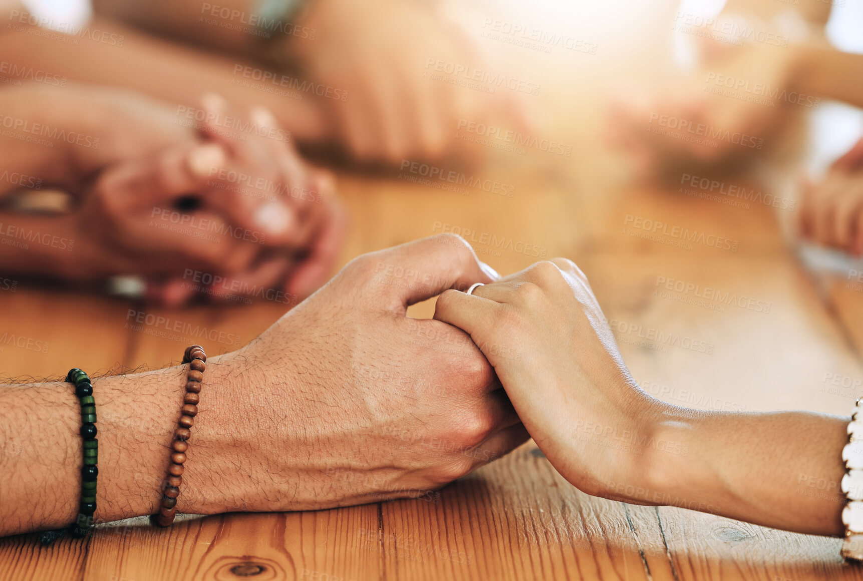 Buy stock photo Holding hands, family and support by group of people together in unity, spiritual and faith in God and gratitude. Closeup, Solidarity, religion and hope in a home for worship due to grief