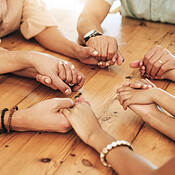 Holding hands, praying and support by group of people or family ...