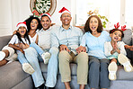 Christmas, portrait and smile of big family on sofa in home living room, bonding and laughing at funny joke. Love, xmas holiday and care of happy children, parents and grandparents sitting on couch.