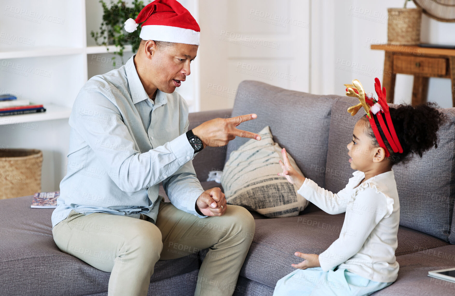 Buy stock photo Senior family and kid play Christmas game together for fun, learning and bonding with numbers education. Grandfather or mature man talking and teaching girl child in lounge for thanksgiving holiday