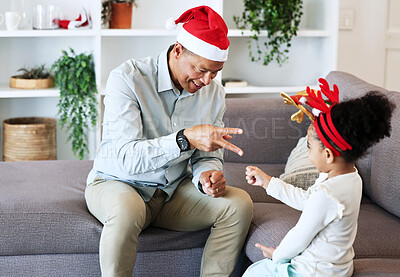 Buy stock photo Rock, paper, scissors at Christmas with a father and daughter in the living room of their home together. Black family, love or bonding with a man and girl child playing games in their house