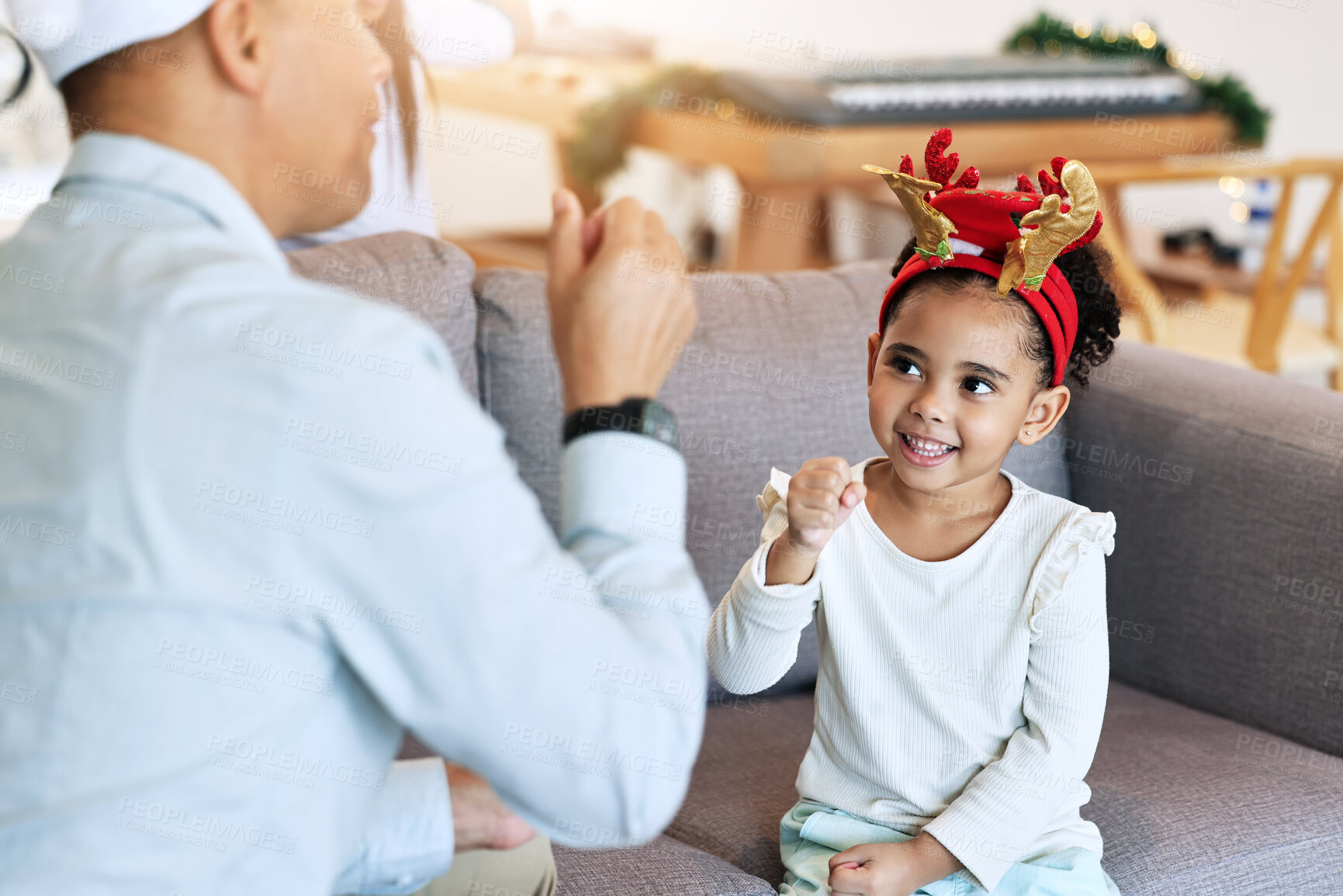 Buy stock photo Christmas, girl and home holiday fun with a father and parent care on a living room sofa. Family, vacation bonding and happiness of a child and dad ready for celebration with party hats in a house
