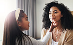 Happy, makeup and lipstick with mother and daughter for bonding, playing and affectionate. Care, happiness and relax with black woman and child in family home for cosmetics, relax and grooming