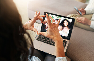 Buy stock photo Hand heart, video call and love with laptop screen, family and communication with emoji, connection and bonding. Hands, relax at home and happy with care, connectivity and virtual chat in lounge