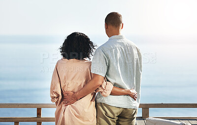 Buy stock photo Back, view and senior couple by beach, hug and enjoying quality time on holiday or vacation. Love, care and retired elderly man and woman hugging, embrace or cuddle while having fun by ocean or sea.