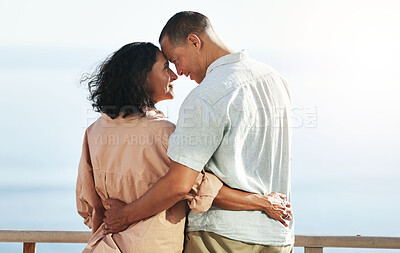 Buy stock photo Love, back and senior couple by beach, hug and enjoying quality time on holiday or vacation. Romance, care and retired happy man and woman hugging, embrace or cuddle while having fun by seashore.