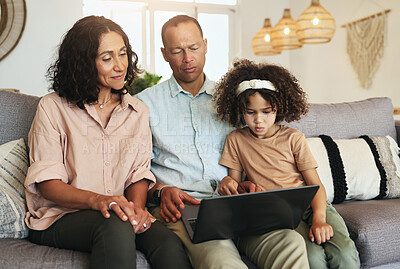 Buy stock photo Girl watching a movie on laptop with her grandparents while relaxing on sofa in the living room. Technology, rest and child streaming video or film with grandfather and grandmother for entertainment.