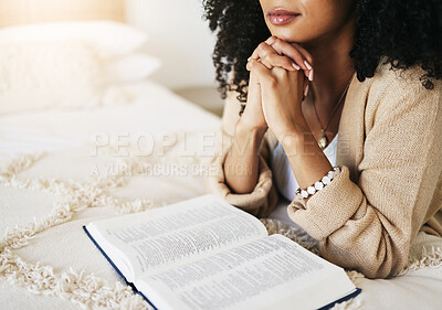 Bible, prayer and hands praying for hope, religion or help, spiritual or faith in home. God, christian and female or woman worship Jesus Christ or Holy Spirit with catholic text or book for peace.