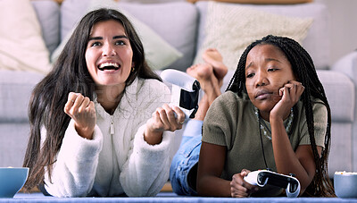 Buy stock photo Gaming, winner and women playing a video game and girl celebrating in a home, house or apartment. Friends, console and people with joystick and jealous person due to victory with controller