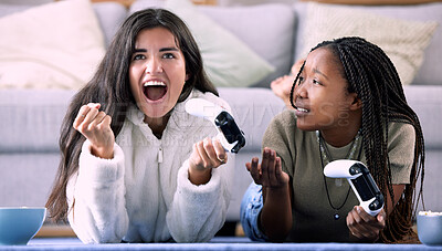 Buy stock photo Celebrate, controller and friends playing a game in the living room for entertainment, fun and bonding. Happy, celebration and interracial women enjoying a gaming competition together at their home.