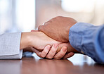 Couple, holding hands and support on table in care, compassion or trust for partnership together. Man and woman touching hand in unity, empathy or understanding for commitment in solidarity on desk