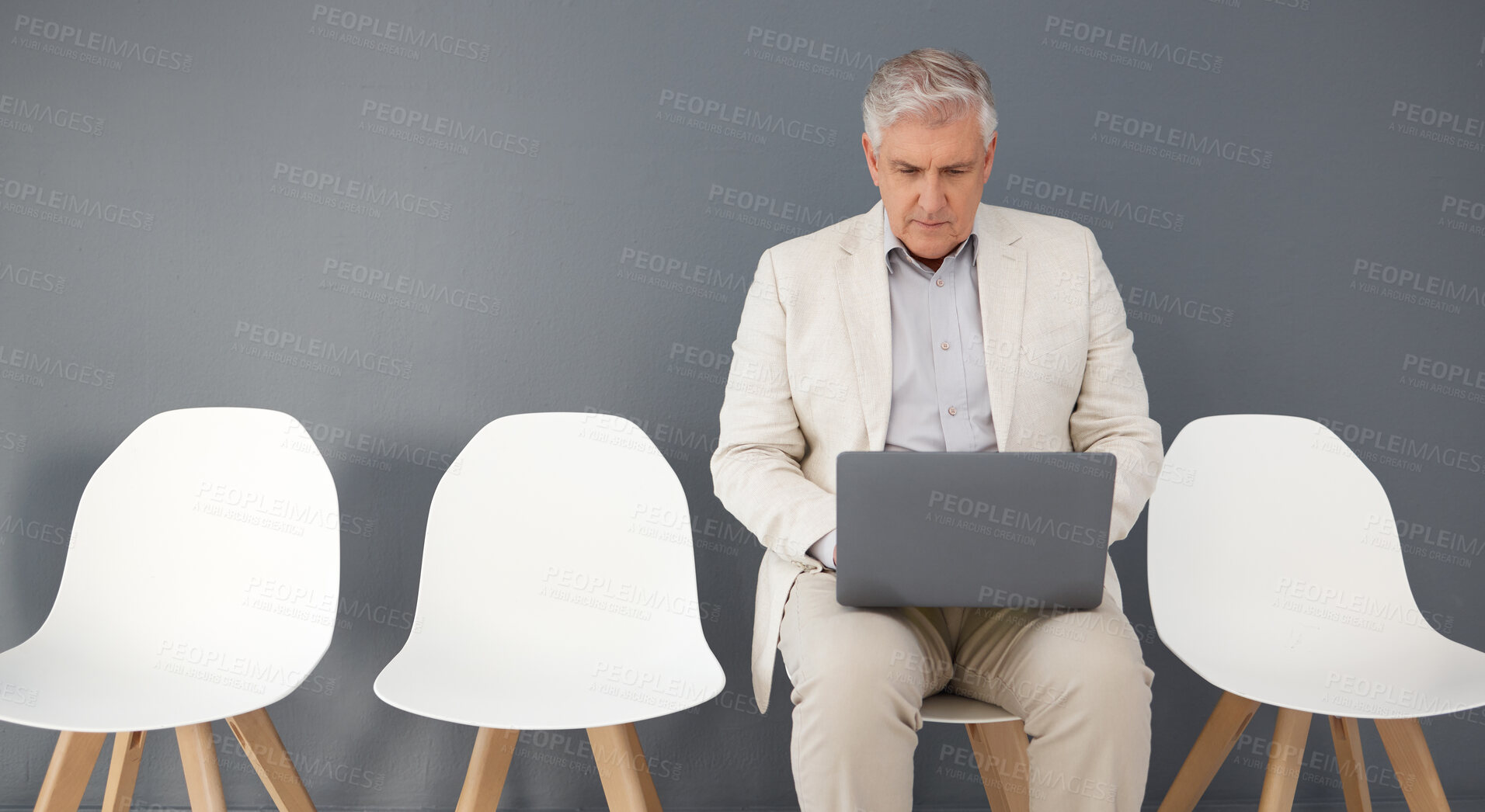 Buy stock photo Mature business man, laptop and waiting room, queue and interview line of opportunity, recruitment process or mockup. Executive manager working on technology at studio wall, computer or hiring worker