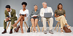 HR, technology and business people waiting in line for an interview during recruitment. Hiring, resume or cv with a man and woman employee sitting in a human resources candidate line for opportunity