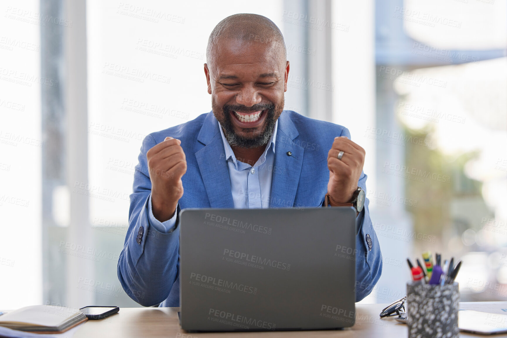 Buy stock photo Happy black man, laptop and celebration for winning, sale or good news on discount at the office desk. Excited African American male celebrating on computer for promotion, bonus or achievement