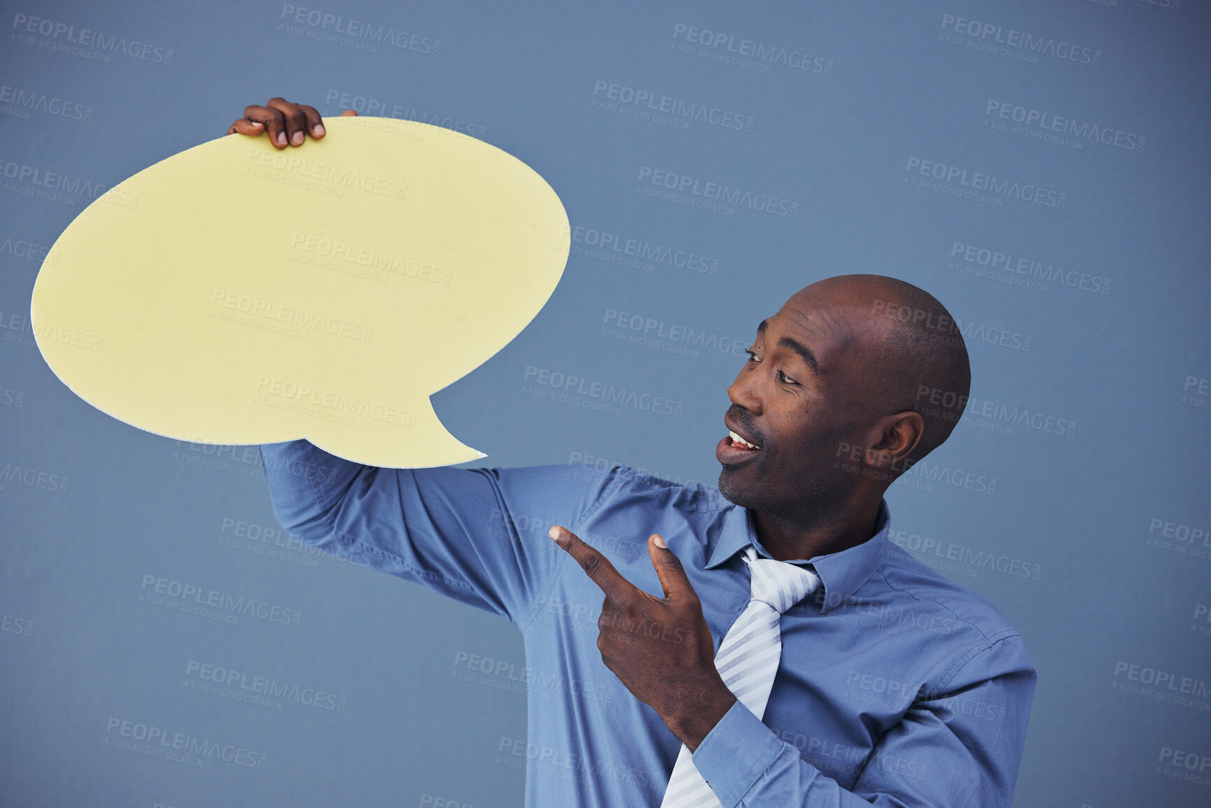 Buy stock photo Black man, social media and mockup with speech bubble for advertising or marketing against a blue studio background. African American male pointing to shape for voice, opinion or text advertisement