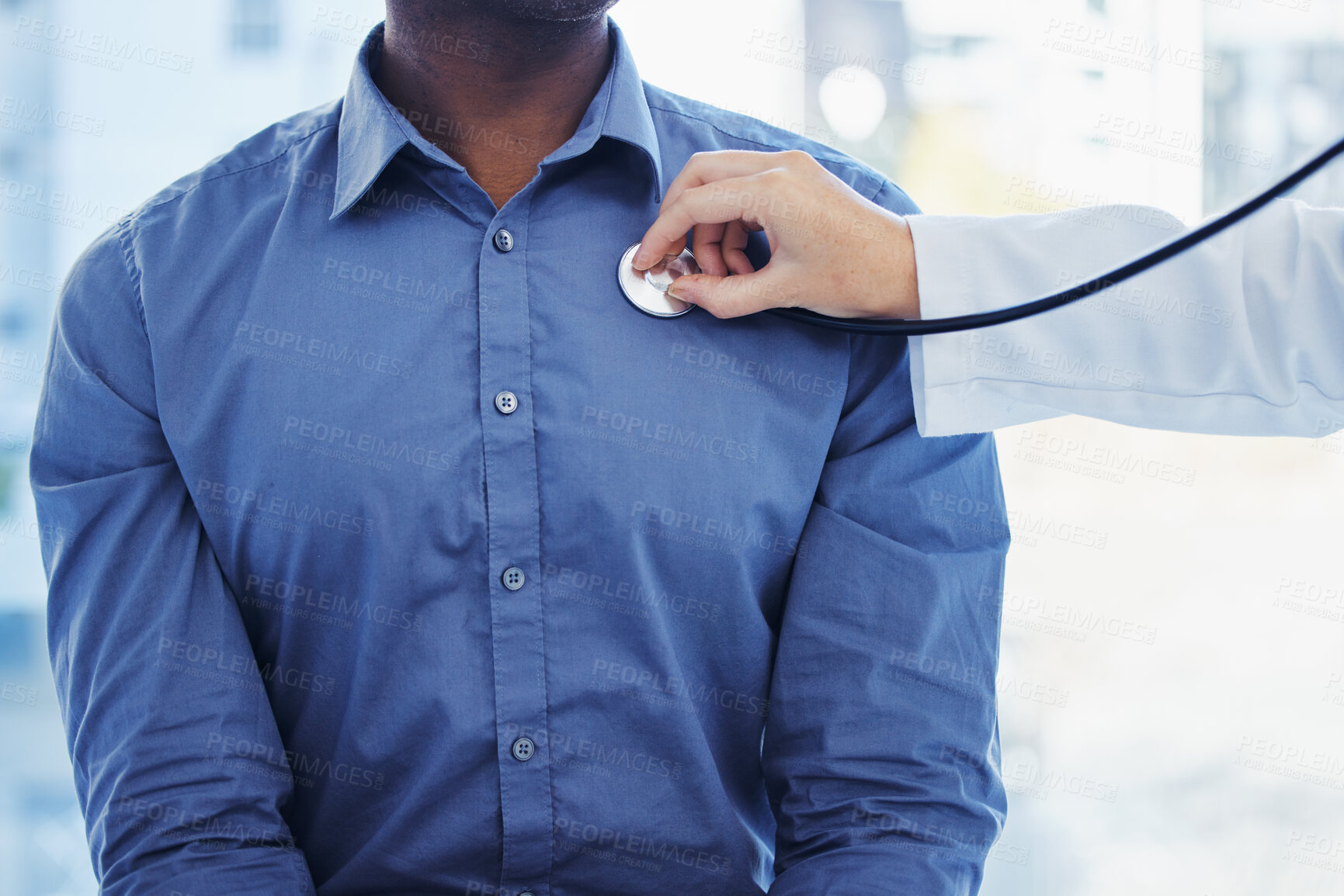 Buy stock photo Doctor, patient and consultation with stethoscope on heart in hospital for healthcare or health insurance. Black man and cardiology  person check lungs, breathing and wellness of body and organ