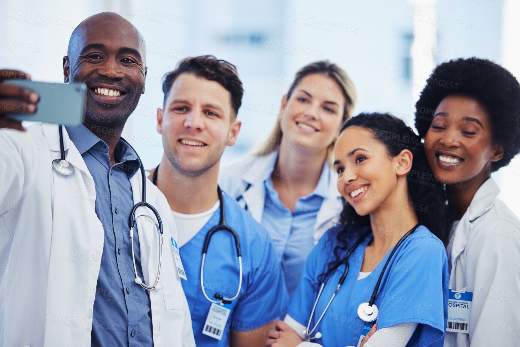 Buy stock photo Healthcare, selfie and team of doctors at hospital, happy and proud, smile and bond on blurred background. Medical, diversity and group pose for photo, profile picture or website homepage update 