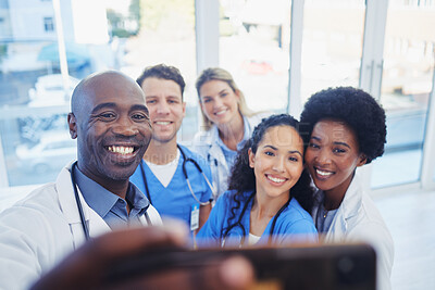 Buy stock photo Healthcare, team and selfie by doctors at hospital, happy and proud , smile and bond on blurred background. Medical, diversity and group pose for photo, profile picture or website homepage update 