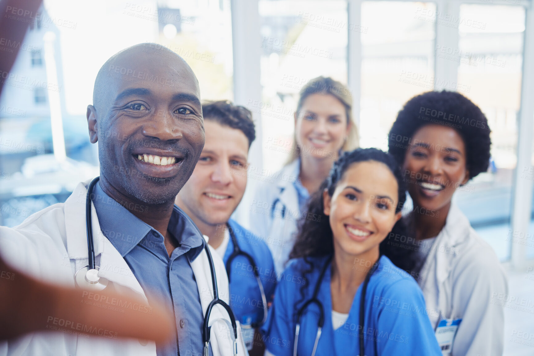 Buy stock photo Healthcare, portrait and selfie by doctors at hospital, happy and proud, smile and bond on blurred background. Face, diversity and group pose for photo, profile picture or website homepage update 