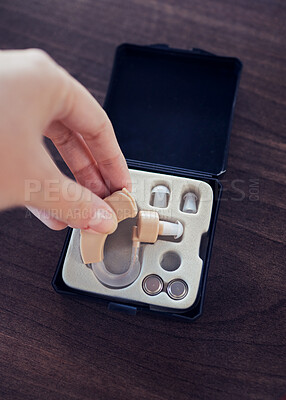 Buy stock photo Disability, hearing aid and healthcare with hands of woman for ear implant, medical and technology. Medicine, audiology and listening devices for deaf with patient for sound, communication and help