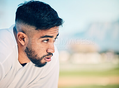 Buy stock photo Tired, breathing and sports man at a field for training, break and breathing exercise on blurred background. Athletic, sports and indian guy stop to breathe after exercise, workout or match practice