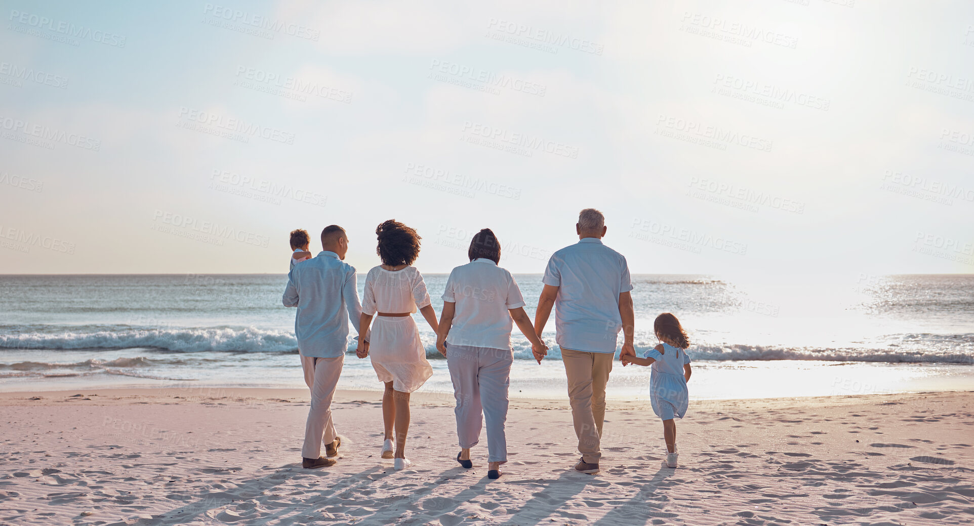 Buy stock photo Grandparents, parents and children walking on beach for holiday, vacation and weekend by sea. Travel, sunset and kids holding hands with big family for adventure, journey and relax for bond together