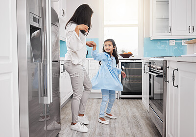 Buy stock photo Mother, dancing and girl in the kitchen with bonding, parent care and love in a family home. Mom child and happy dance in a house with happiness, fun and dancer activity with mama support in morning