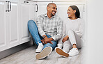 Love, happy and couple relax on a floor, talking and bonding in their home kitchen with coffee. Marriage, tea and man sitting with woman, laughing and enjoying conversation and relationship indoors