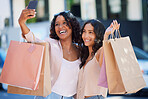 Woman, friends and shopping with smile for selfie in the city or social media post and vlog for sale, discount or friendship. Happy women smiling for photo, gift bags or memory together in urban town