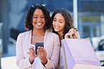 Black woman, phone and online shopping with friends, city and bag with smile, meme and excited. Women, smartphone and texting in metro on social media app with happiness in summer with e-commerce ux