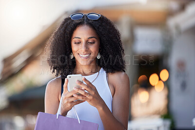 Buy stock photo Black woman, phone reading and shopping bag of a customer on a online shop app for discount. Retail store promotion, urban and mobile networking of a female on a city street with blurred background