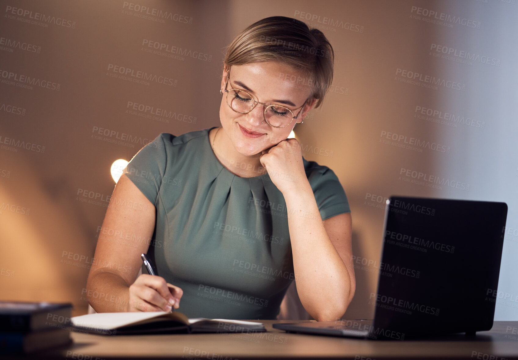 Buy stock photo Business woman, notebook or writing in night office for company planning, schedule or ideas management. Smile, happy or corporate worker with book, laptop technology or project agenda of evening task