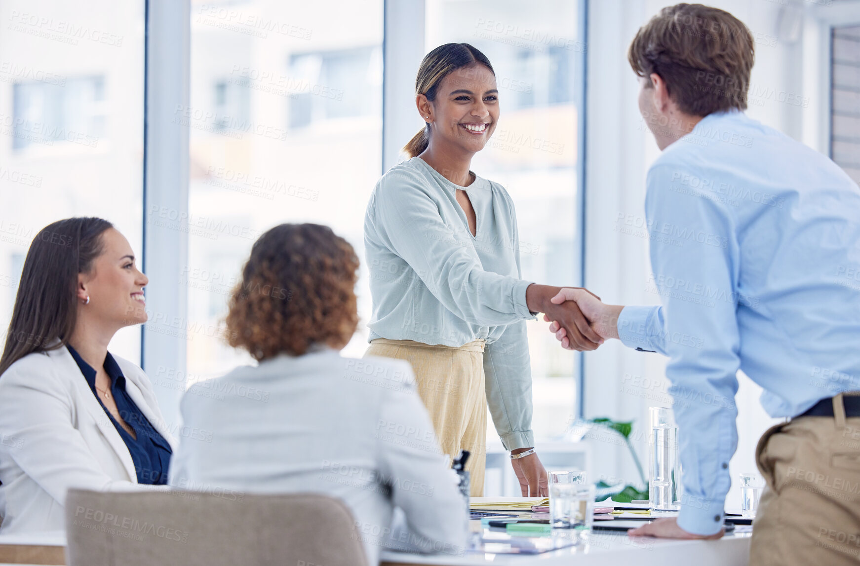 Buy stock photo Business, handshake and staff in meeting, promotion and celebration in workplace, happiness and recruitment. Black woman, group and teamwork with gesture for partnership, collaboration and management