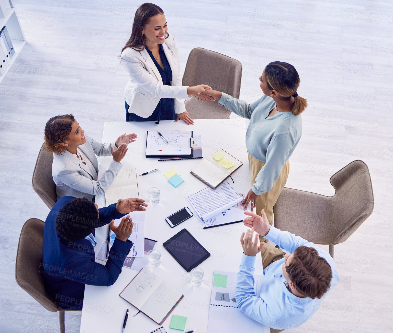 Buy stock photo Handshake, applause and an overhead meeting in a boardroom for celebration of an achievement or promotion. Thank you, welcome or greeting with business women shaking hands in agreement at the office