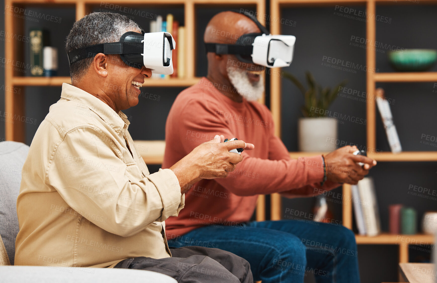 Buy stock photo Gaming, metaverse and senior black man friends playing a video game together in the living room of a home. Sofa, virtual reality or retirement with a mature gamer and friend enjoying an online game