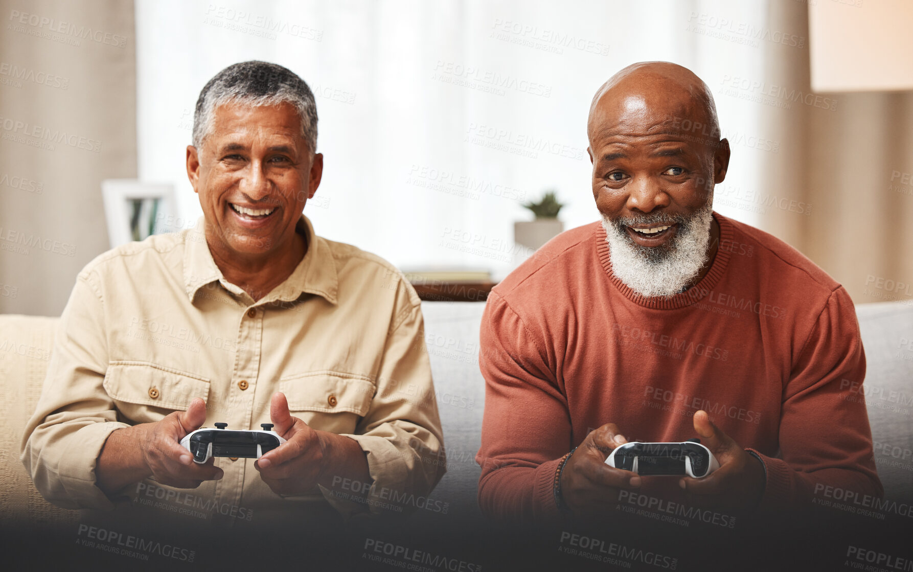 Buy stock photo Gamer, fun and senior black man friends playing a video game together in the living room of a home. Sofa, funny or retirement with a mature male and friend gaming or bonding during a visit in a house