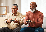 Gaming, funny and senior black man friends playing a video game together in the living room of a home. Sofa, fun or retirement with a mature male gamer and friend enjoying a house visit to game