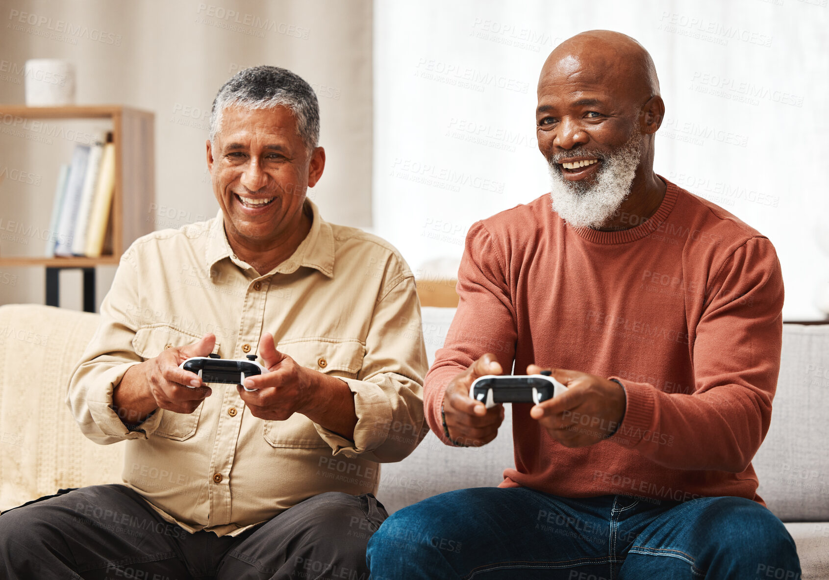 Buy stock photo Gaming, funny and senior black man friends playing a video game together in the living room of a home. Sofa, fun or retirement with a mature male gamer and friend enjoying a house visit to game